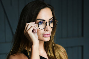 Beautiful woman wearing prescription glasses with anti-reflective coating 